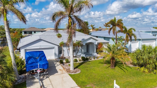 view of front of property featuring a garage and a front yard