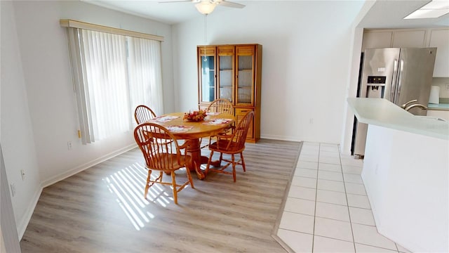 dining area featuring ceiling fan, light wood-type flooring, and a wealth of natural light