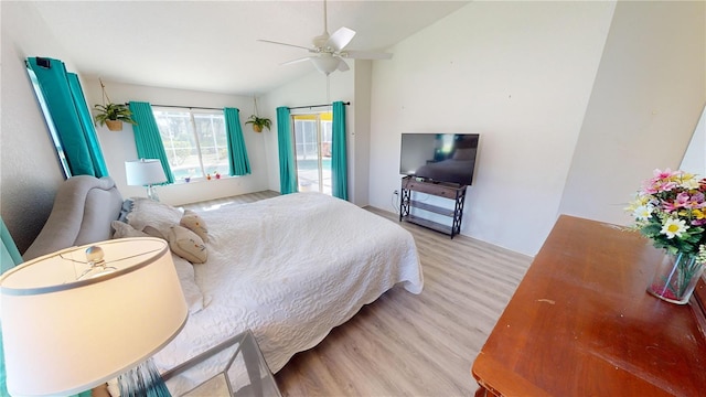 bedroom with light wood-type flooring, vaulted ceiling, and ceiling fan