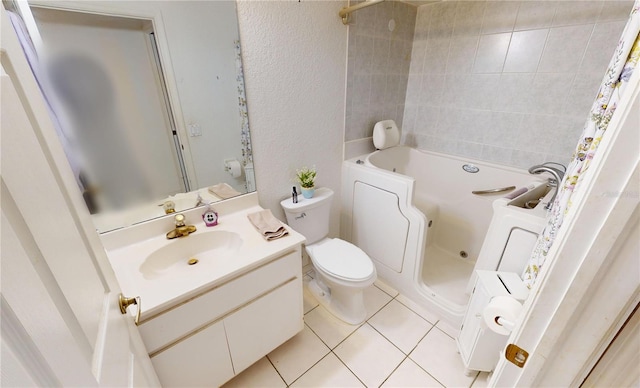 bathroom featuring a tub to relax in, tile patterned flooring, vanity, and toilet