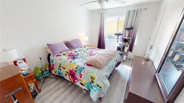 bedroom with light wood-type flooring and ceiling fan