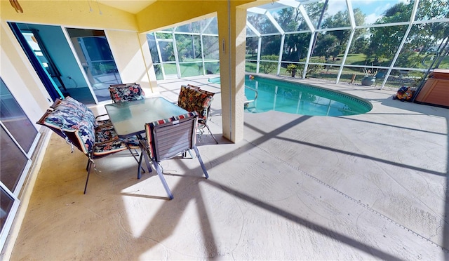 view of swimming pool featuring a lanai and a patio