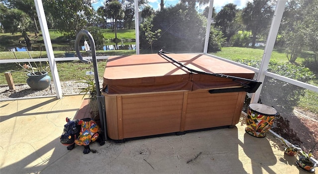 unfurnished sunroom with a water view and a hot tub