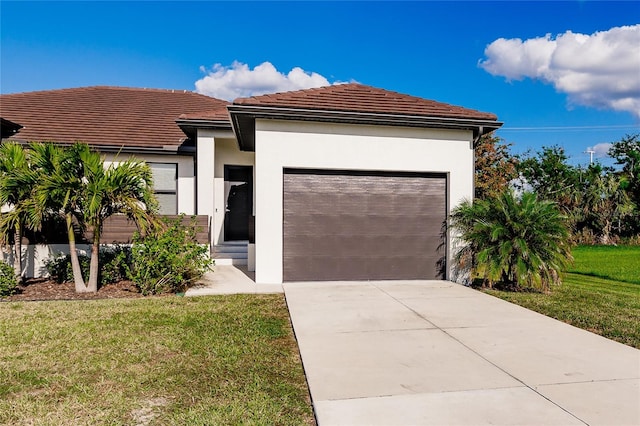 view of front facade with a front yard and a garage