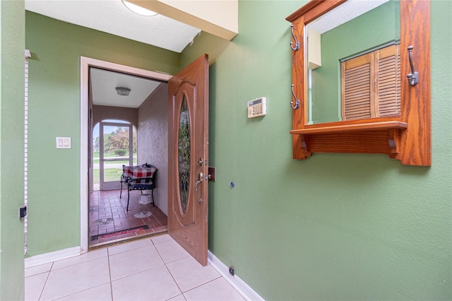 hall with light tile patterned floors