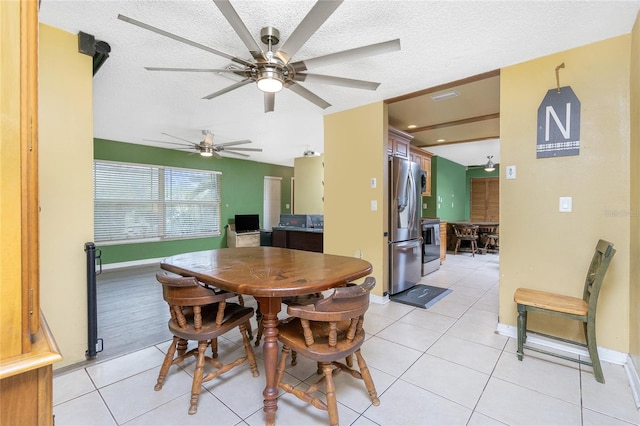 3545 Syracuse St, Port Charlotte, FL 33952 - dining space with a textured ceiling, a ceiling fan, light tile patterned floors, and baseboards