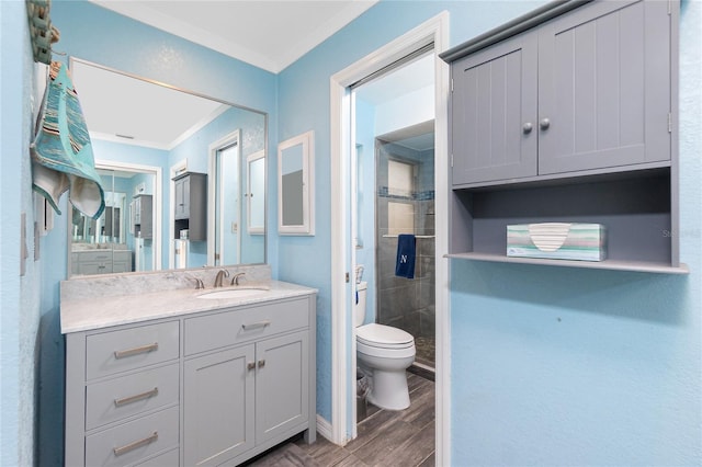 bathroom with toilet, vanity, hardwood / wood-style flooring, and crown molding