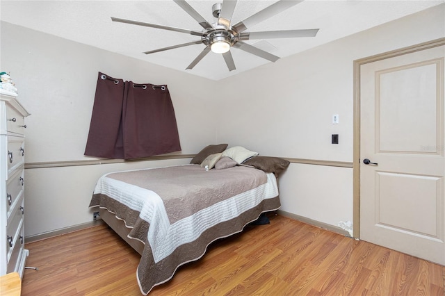 bedroom with ceiling fan and light hardwood / wood-style flooring