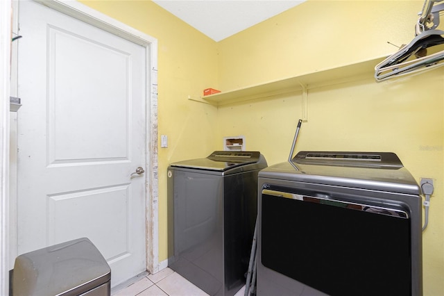 laundry area with light tile patterned flooring and independent washer and dryer