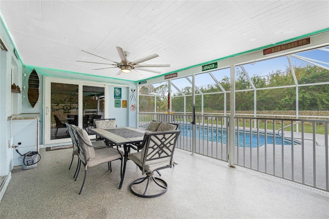 sunroom / solarium featuring ceiling fan