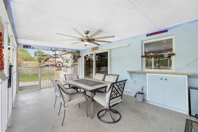 sunroom / solarium featuring ceiling fan