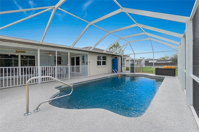 view of pool with ceiling fan, a lanai, and a patio area