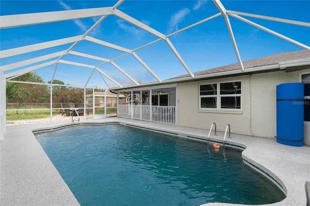 view of swimming pool featuring a patio and a lanai