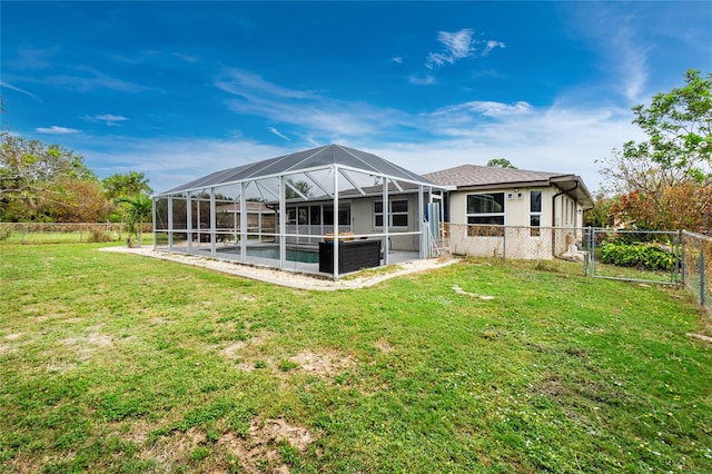 back of house featuring a yard, glass enclosure, and a pool