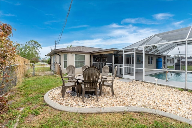 back of house with a patio, a fenced in pool, and glass enclosure