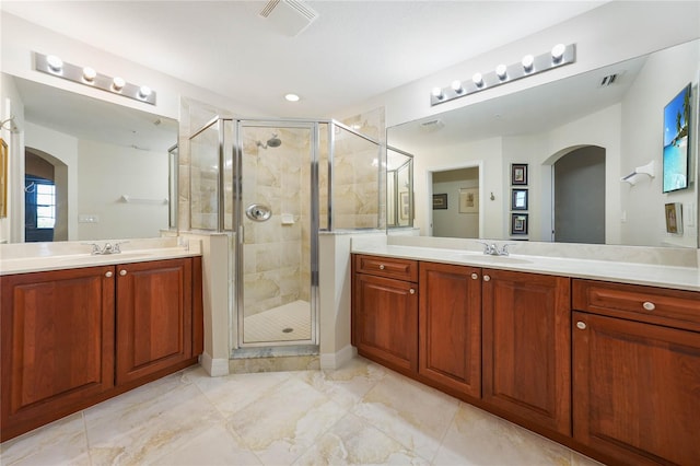 full bathroom with a shower stall, visible vents, and a sink