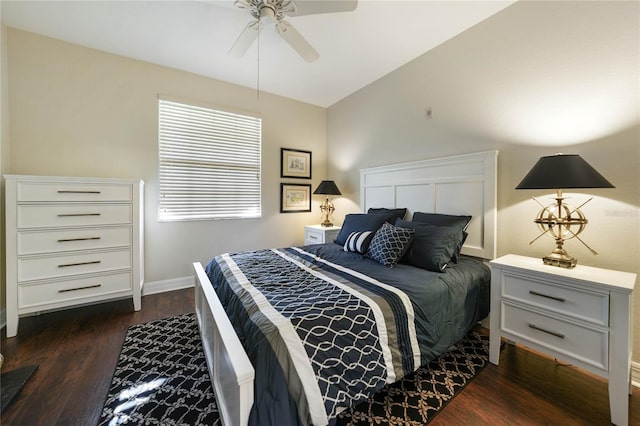 bedroom featuring lofted ceiling, a ceiling fan, baseboards, and dark wood-type flooring