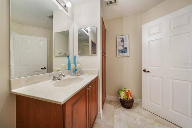 bathroom featuring baseboards, visible vents, and vanity