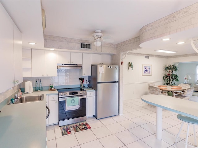 kitchen with stainless steel appliances, light tile patterned floors, sink, white cabinets, and ceiling fan