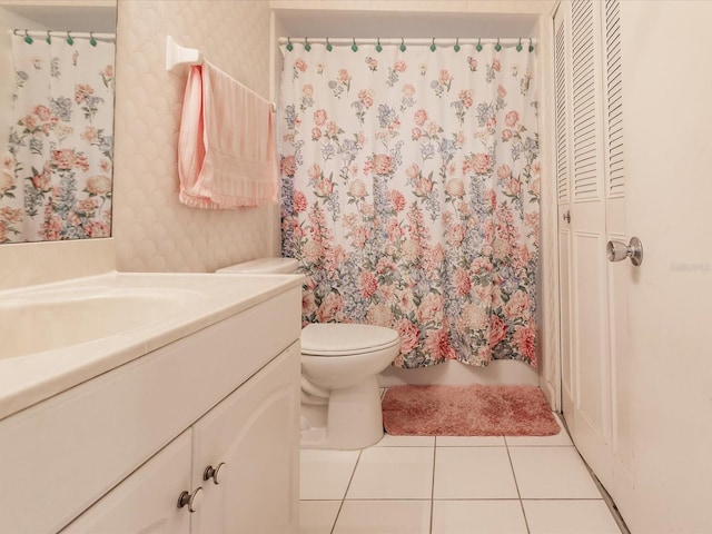 bathroom featuring toilet, vanity, and tile patterned floors