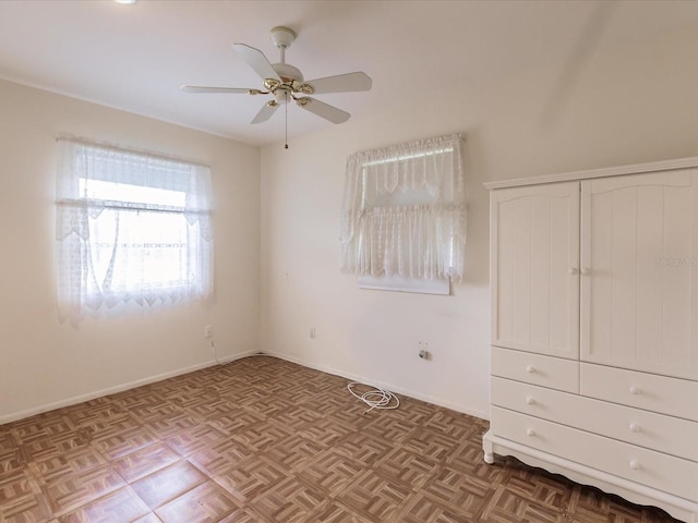 unfurnished bedroom featuring parquet flooring and ceiling fan