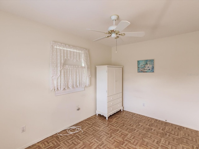 spare room with ceiling fan and light parquet floors