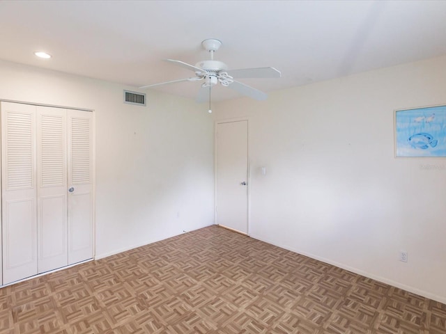 unfurnished bedroom with ceiling fan and light parquet flooring