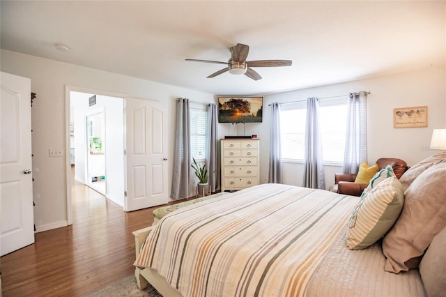 bedroom with access to exterior, hardwood / wood-style floors, and ceiling fan