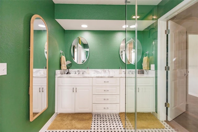 bathroom featuring vanity and a shower with door