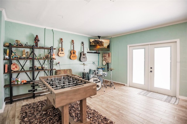 game room featuring hardwood / wood-style floors, french doors, and ornamental molding