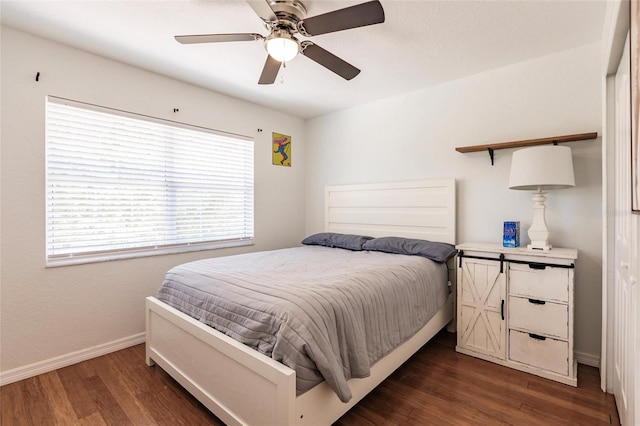 bedroom with dark hardwood / wood-style floors and ceiling fan