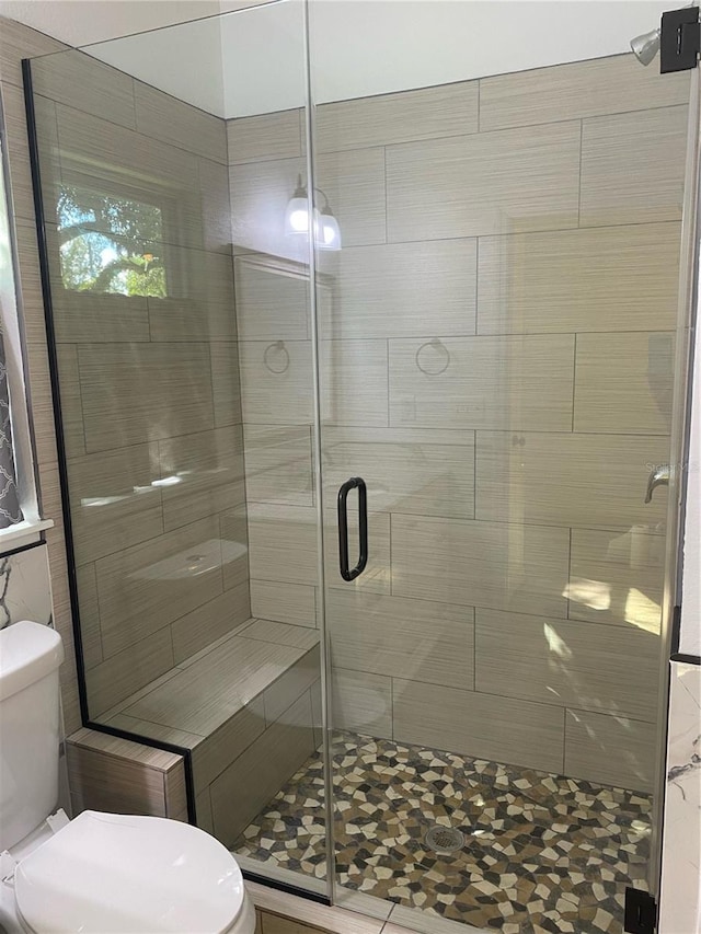 bathroom with walk in shower and toilet