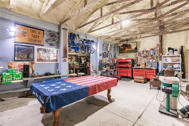 playroom with a workshop area, concrete flooring, pool table, and lofted ceiling