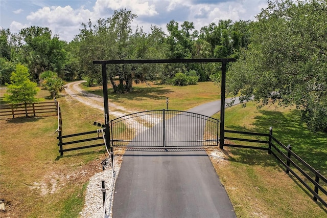 view of gate featuring a yard