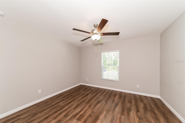 spare room with ceiling fan and dark hardwood / wood-style flooring