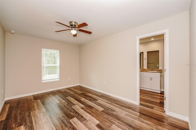 spare room with hardwood / wood-style flooring, sink, and ceiling fan