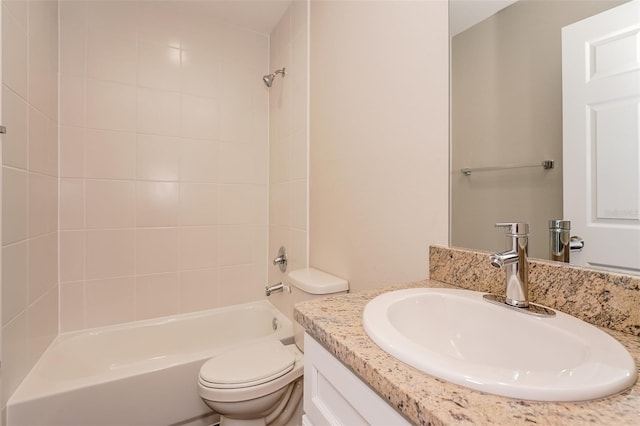 full bathroom with vanity, tiled shower / bath combo, and toilet