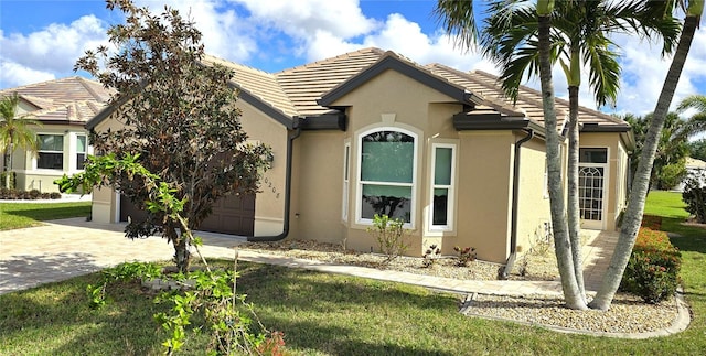 view of front facade with a front yard and a garage