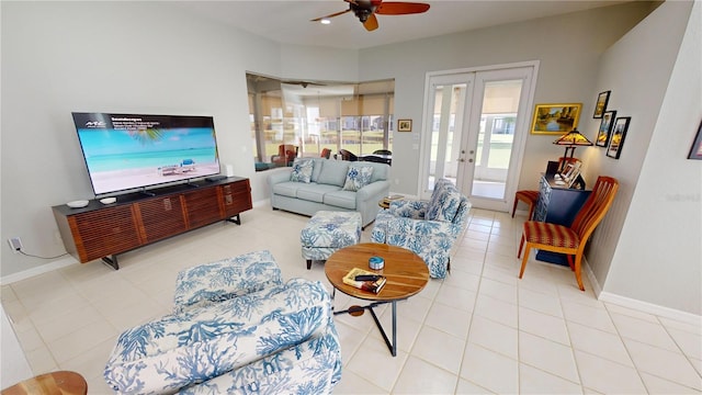 tiled living room with ceiling fan and french doors