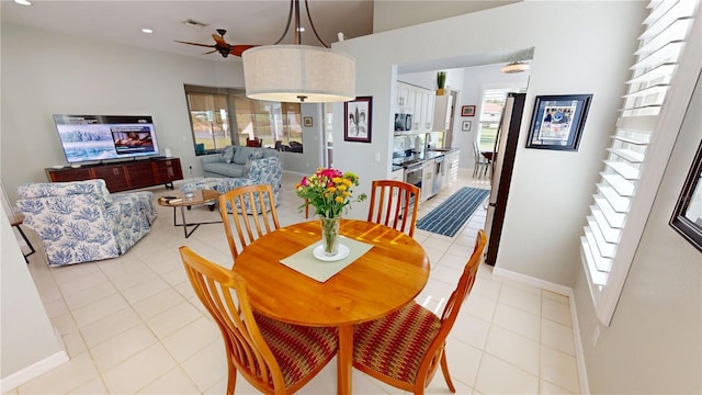 tiled dining room with ceiling fan