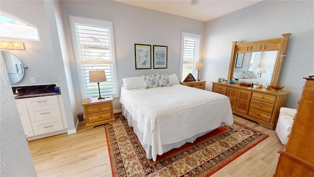 bedroom featuring light wood-type flooring and multiple windows