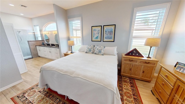 bedroom featuring light wood-type flooring and multiple windows