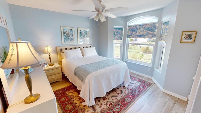 bedroom with light wood-type flooring and ceiling fan