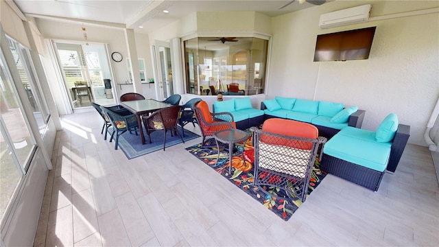 living room featuring a wall unit AC, ceiling fan, and light hardwood / wood-style flooring