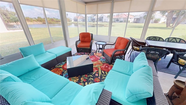 sunroom featuring plenty of natural light and a water view