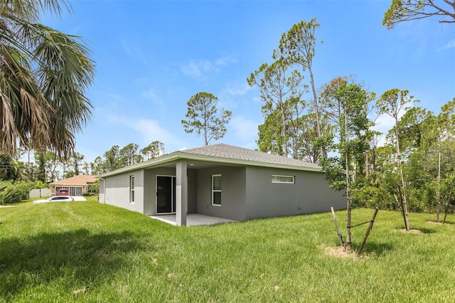 rear view of property with a patio area and a yard