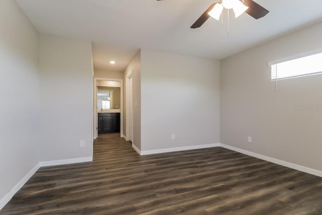 unfurnished room featuring dark wood-type flooring and ceiling fan