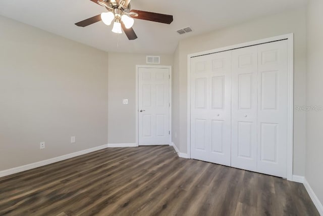 unfurnished bedroom with ceiling fan, a closet, and dark hardwood / wood-style flooring