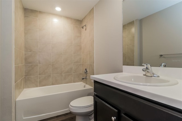 full bathroom featuring toilet, vanity, tiled shower / bath, and hardwood / wood-style flooring