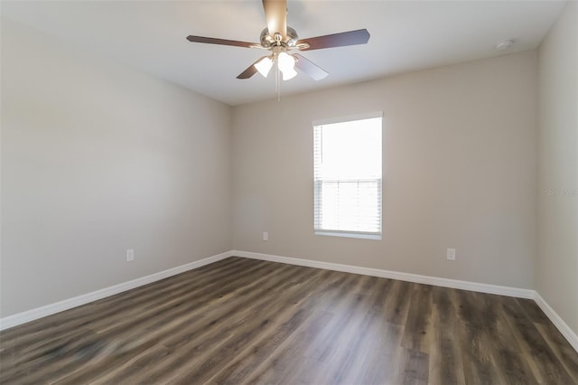 unfurnished room featuring dark wood-type flooring and ceiling fan